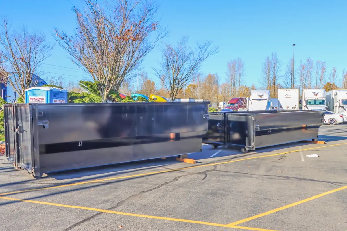 Professional dumpster rental service with roll-off container on residential driveway in Chubbuck